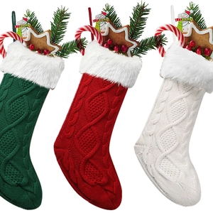 Three knitted Christmas stockings in red, green, and white with plush faux fur trim detail