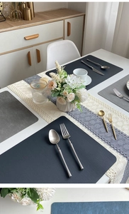 Detailed view of linen texture placemats and beige blue woven runner with tassels