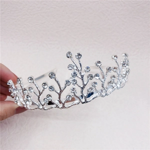 Macro detail of silver rhinestone crown headband with elegant vine-like alloy design