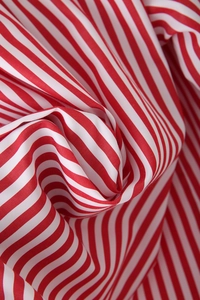 Macro shot of red and white striped poplin fabric showing fine texture and weave detail