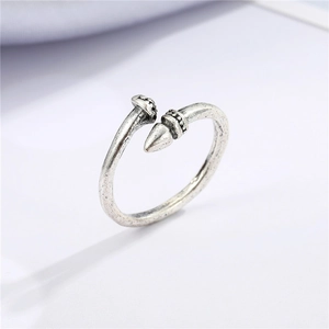 Macro shot of vintage silver adjustable ring featuring punk nail and arrow details
