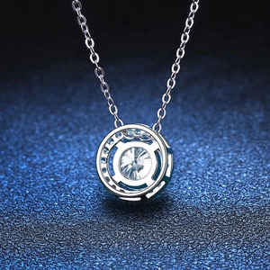 Elegant 925 sterling silver moissanite necklace with round pendant on blue background