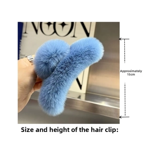Detail shot of large light blue plush shark hair claw clip measuring 15cm for thick hair