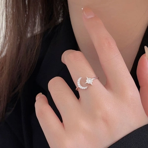 Detail of 925 silver ring featuring micro-pasted moon and star with sparkling crystals