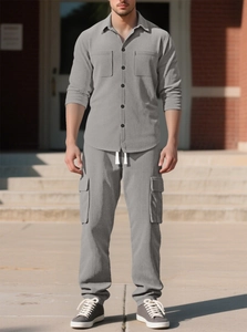 Detail showing grey corduroy texture and cargo pocket design on a men's casual two-piece suit