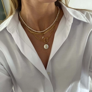 Detailed view of layered 18K gold-plated stainless steel necklaces with lightning charms