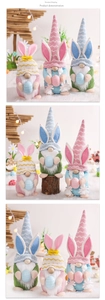 Close-up of three Easter gnomes with rabbit ears holding striped eggs for festive decor