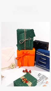 Detail of luxury Christmas gift wrapping paper with gold foil speckles and ribbons