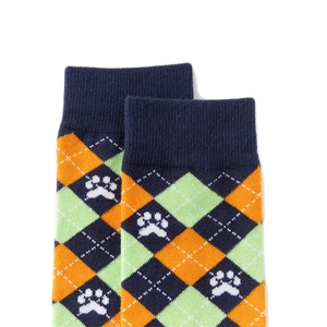 Detail of argyle knit socks with blue and orange patterns and white animal paw prints
