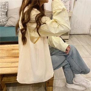 Minimalist beige canvas tote bag shown in a lifestyle setting with a soft warm aesthetic