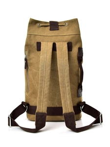 Versatile canvas cylinder backpack in mustard yellow with brown leather accents and side zip