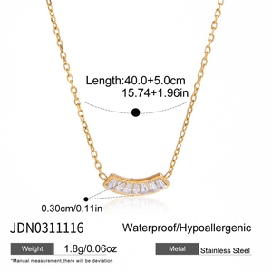 Detail showing the polished gold stainless steel chain and clear rectangular zircon pendant
