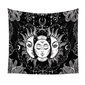 Close-up of bohemian wall tapestry featuring celestial sun, moon and star patterns