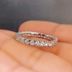 Close-up of minimalist silver band ring featuring a full circle of shimmering pave zircon