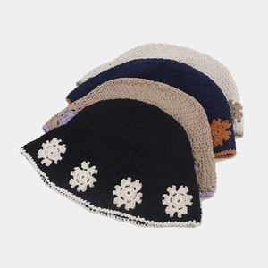 Detail of crochet bucket hats with floral patterns in black, coffee, navy and cream