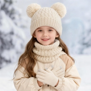 Close-up of beige knit baby hat, scarf and gloves with classic texture for winter