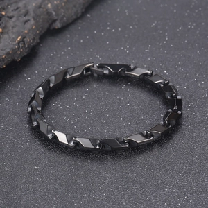 Minimalist hip-hop titanium steel prism chain bracelet on textured stone background