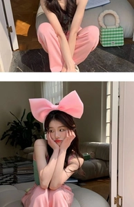 Detailed close-up showing a large pink bow headband worn by a model in a lifestyle setting