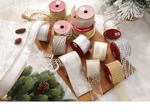 Detail of assorted Christmas ribbons with snowflakes and trees on wooden board