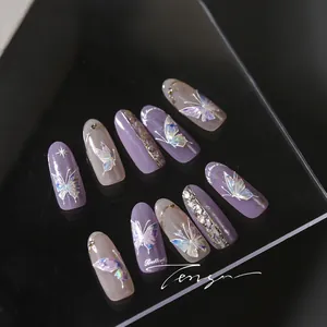 Detailed macro view of lilac 3D laser butterfly nail charms with rhinestones