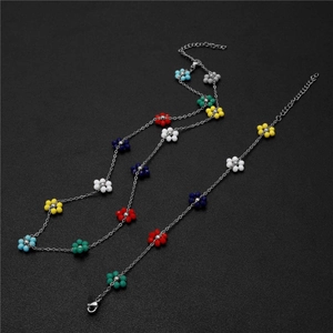 Summer vacation stainless steel bracelet set with colorful bead flowers on black texture
