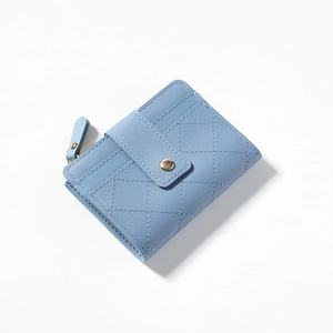 Detail of light blue short wallet featuring quilted stitching and golden metal snap button