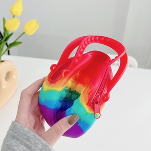 Close-up of rainbow silicone pop fidget handbag with red handle and zipper detail