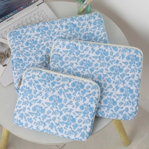 Blue floral quilted laptop sleeve set in three sizes with protective diamond stitching