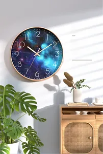 Detail of creative silent starry sky wall clock with gold metal frame for living room