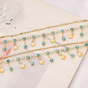 Golden layered necklace with blue crystals and shell pendants in a summer ocean style