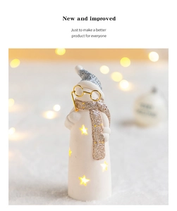 Detail of ceramic snowman lamp with star cut-outs and warm LED glowing effect