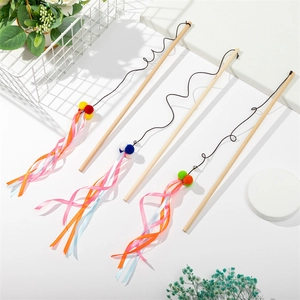 Detailed view of three cat teaser wands with colorful plush balls and ribbon tassels