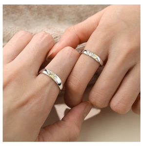 Close-up of S925 sterling silver sun and moon couple rings worn by hand models