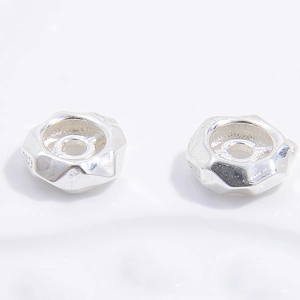 Macro detail of S925 sterling silver irregular faceted spacer beads for DIY jewelry