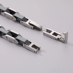 Macro detail of silver and gunmetal stainless steel bracelet with precision mechanical clasp