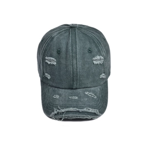 Close-up of distressed vintage dark grey baseball cap with frayed edges and torn details