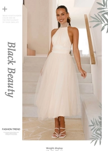 Detail of elegant white mesh halter dress with layered tulle skirt and slim waist design