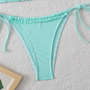 Detail of mint green striped bikini bottoms with ruffle trim and side tie closure