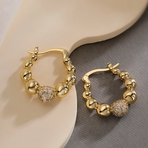 Gold-plated beaded hoop earrings with central clear zircon-studded sphere accent