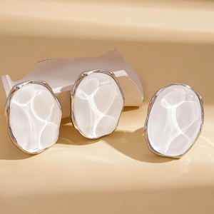 Minimalist geometric resin oval stud earrings with silver borders on artistic stone