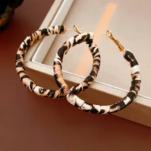 Retro leopard print hoop earrings with golden metal hooks shown on jewelry box