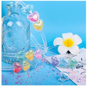 Detail of transparent heart-shaped headbands with colorful glitters in macaron shades