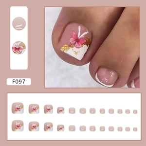 White French tip press-on toenails with pink butterfly designs and gold foil accents