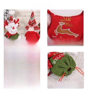 Detail of Christmas knitted drawstring gift bag with embroidered reindeer and snowman motifs
