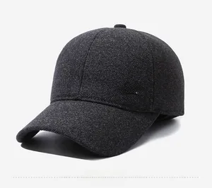 Detail shot of a dark gray textured baseball cap with a premium gold metal logo