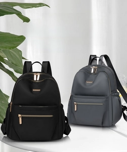 Detailed close-up of nylon backpack zippers and metal accessories in black and grey