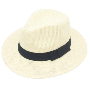 Close-up of fine weave texture and black grosgrain ribbon on cream Panama hat