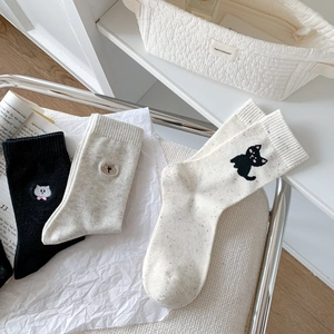Detailed embroidery of animals on breathable cotton crew socks in neutral tones