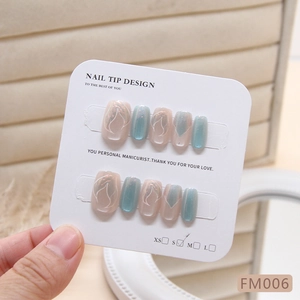 Cat eye press-on nails in pink and grey-blue with flame patterns and glitter finish