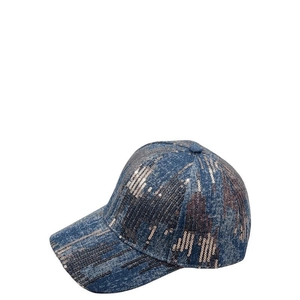 Close-up of sparkling champagne sequins on a blue-grey denim baseball cap surface